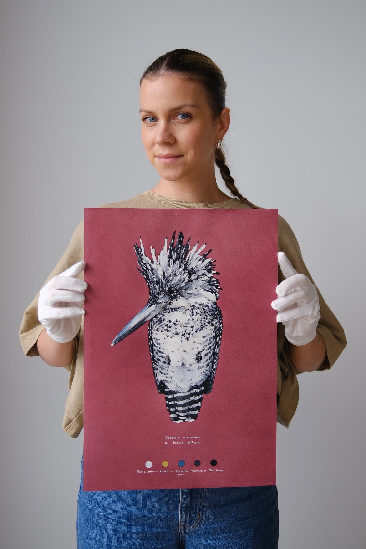 Polina Bright holding the original Crested Kingfisher painting