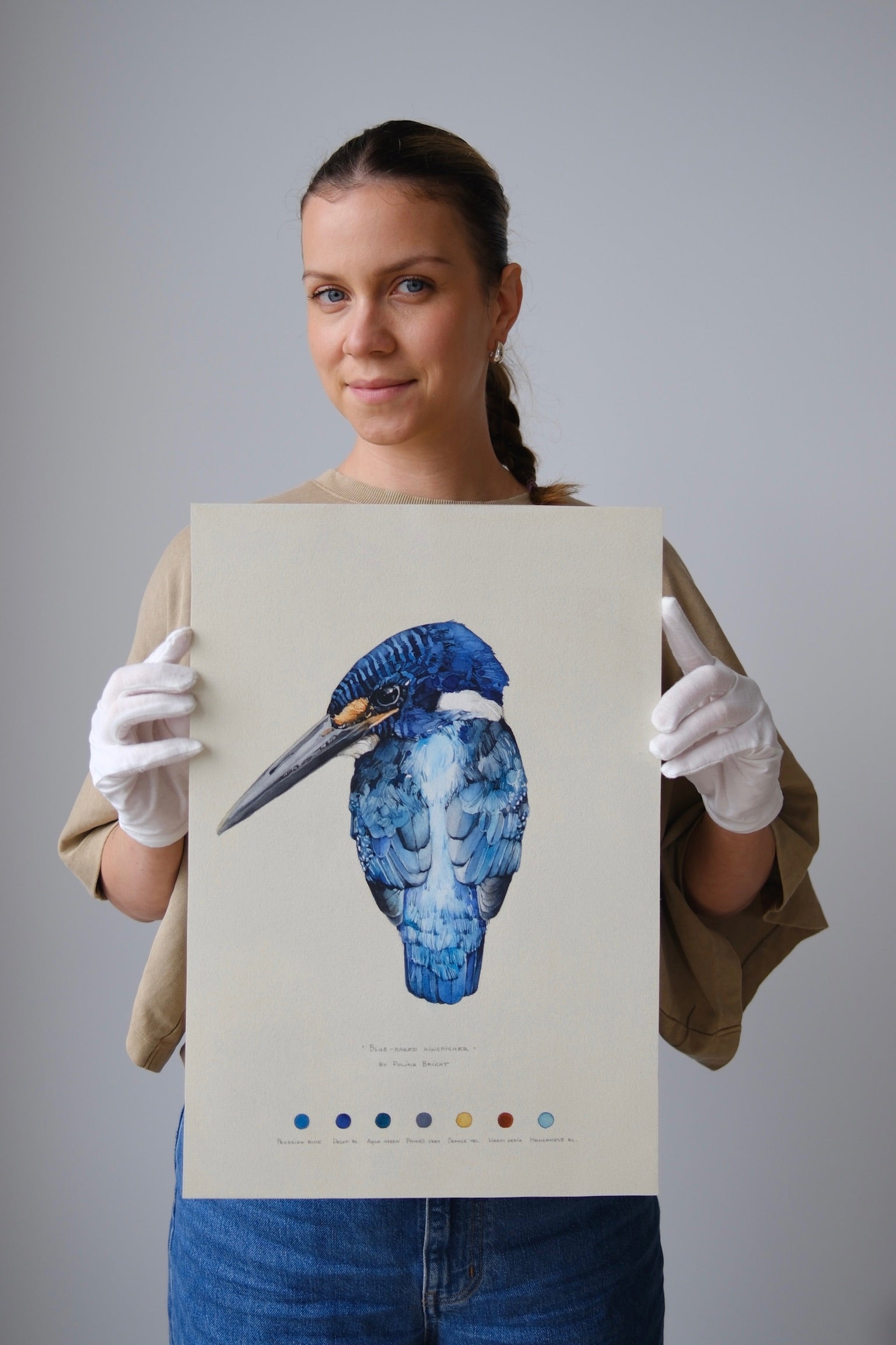 Polina Bright holding the original Blue-eared Kingfisher painting